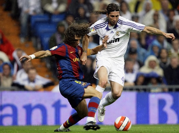 Carles Puyol challenges Sergio Ramos