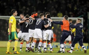 Luton players celebrate their 1-0 victory at Premier League Norwich